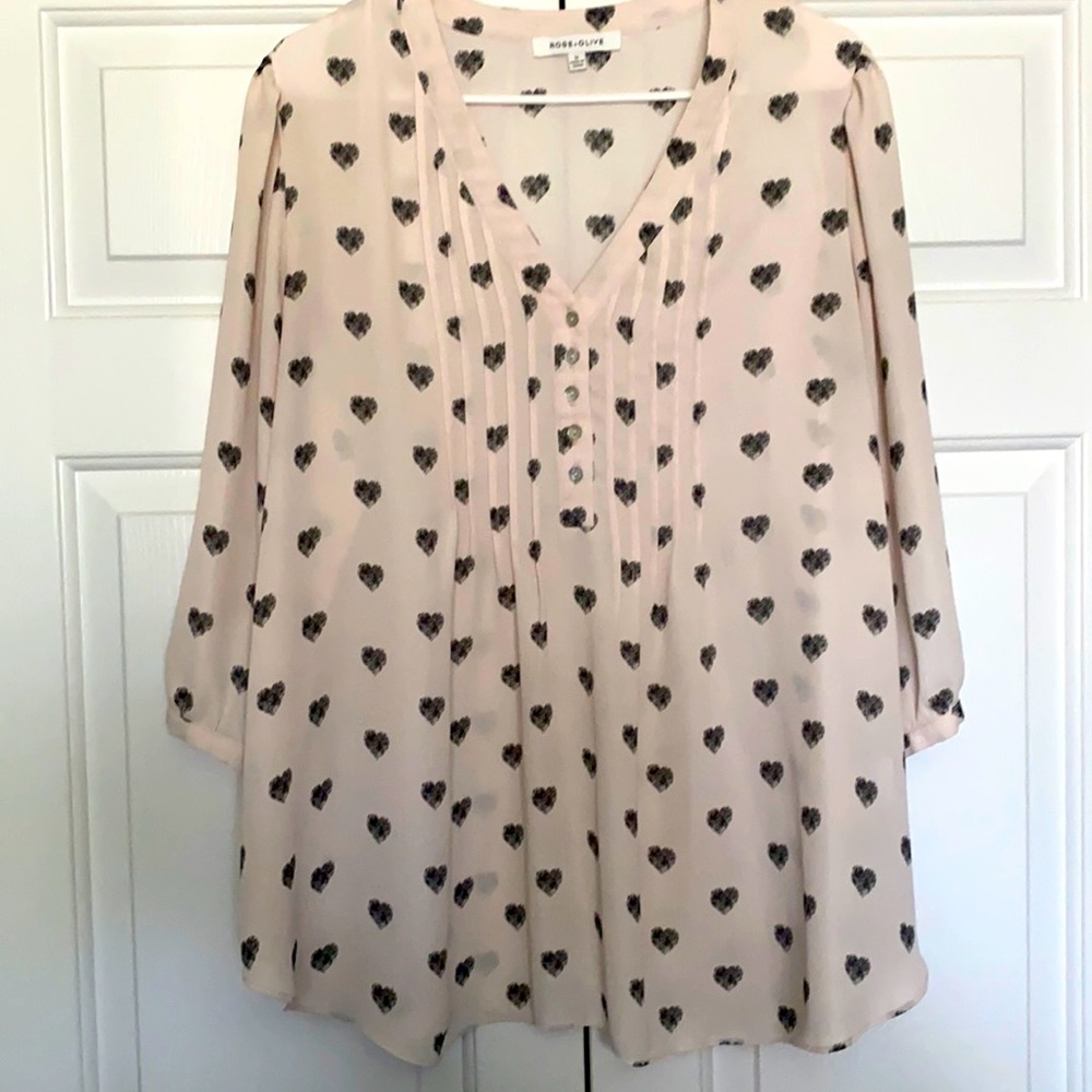 Pink top with black hearts.